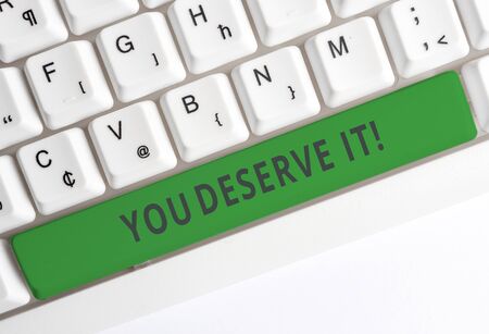 Text sign showing You Deserve It. Business photo showcasing should have it because of their qualities or actions White pc keyboard with empty note paper above white background key copy spaceの写真素材