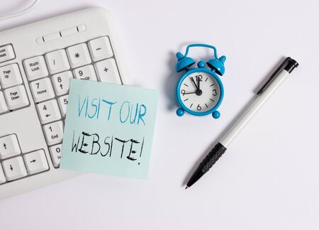 Text sign showing Visit Our Website. Business photo text visitor who arrives at web site and proceeds to browse White pc keyboard with empty note paper above white backgroundの写真素材