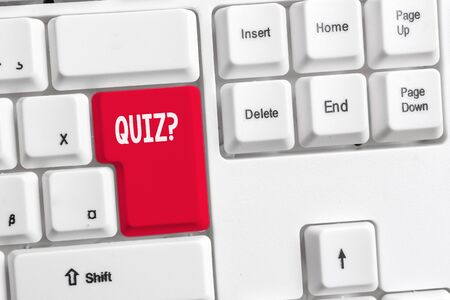 Word writing text Quiz Question. Business photo showcasing test of knowledge as competition between individuals or teams White pc keyboard with empty note paper above white background key copy spaceの写真素材