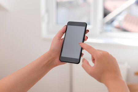 woman using smartphone office supplies technological devices inside homeの写真素材