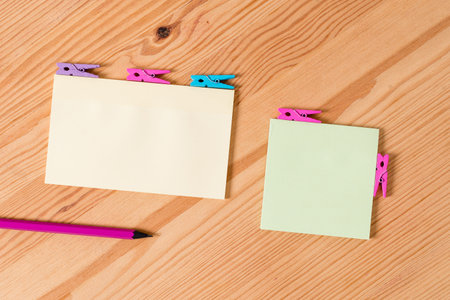 Colored clothespin papers empty reminder wooden floor background office