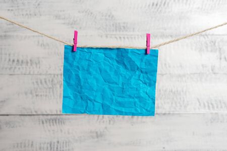 Clothesline clothespin rectangle shaped paper reminder white wood deskの写真素材