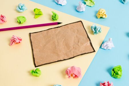Colored crumpled papers empty reminder blue yellow background clothespinの写真素材