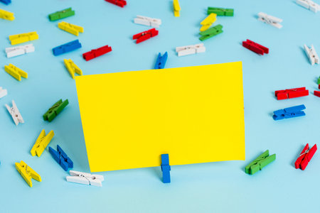 Colored clothespin papers empty reminder blue floor background office pin