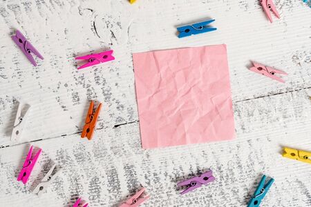 Colored clothespin rectangle square shaped paper white wood backgroundの写真素材