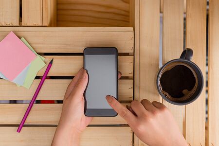 woman computer smartphone drink mug office supplies technological devicesの写真素材