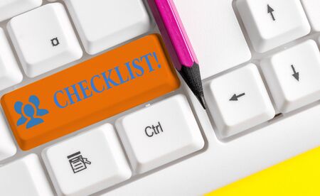 Writing note showing Checklist. Business concept for list items required things be done or points considered White pc keyboard with note paper above the white backgroundの写真素材