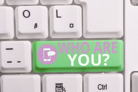 Writing note showing Who Are You question. Business concept for asking demonstrating identity or demonstratingal information Keyboard with note paper on white background key copy spaceの写真素材