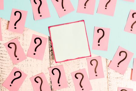 Scribbled and crumbling papers with thick cardboard above wooden table.の写真素材