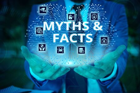 Word writing text Myths And Facts. Business photo showcasing usually traditional story of ostensibly historical events Male human wear formal work suit presenting presentation using smart deviceの写真素材