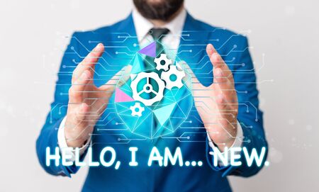 Text sign showing Hello I Am New. Business photo text introducing oneself in a group as fresh worker or student Male human wear formal work suit presenting presentation using smart deviceの写真素材