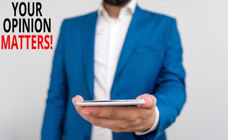 Word writing text Your Opinion Matters. Business photo showcasing show you do not agree with something that just been said Business concept with man holding mobile phone with touch screenの写真素材