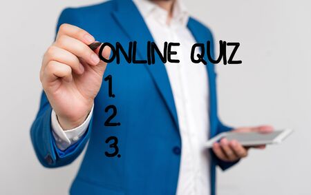 Conceptual hand writing showing Online Quiz. Concept meaning game or a mind sport that are published on the Internet Businessman blue suite and white shirt pointing with fingerの写真素材