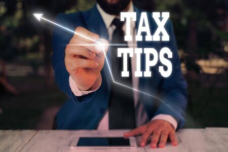 Text sign showing Tax Tips. Business photo showcasing compulsory contribution to state revenue levied by governmentの写真素材