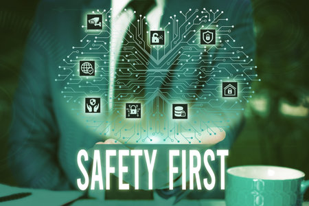 Handwriting text Safety First. Conceptual photo used to say that the most important thing is to be safe Male human wear formal work suit presenting presentation using smart deviceの写真素材