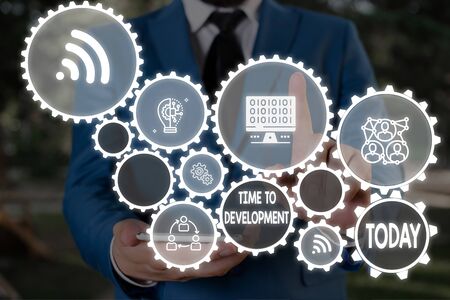 Text sign showing Time To Development. Business photo text a length of time during which a company grows or develop Male human wear formal work suit presenting presentation using smart deviceの写真素材