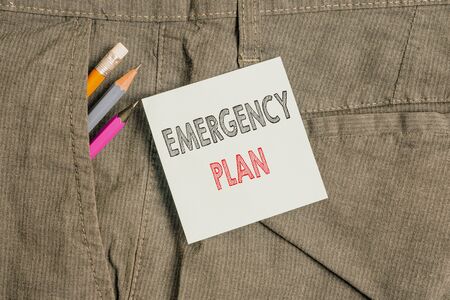 Handwriting text Emergency Plan. Conceptual photo procedures for handling sudden or unexpected situations Writing equipment and blue note paper inside pocket of man work trousersの写真素材