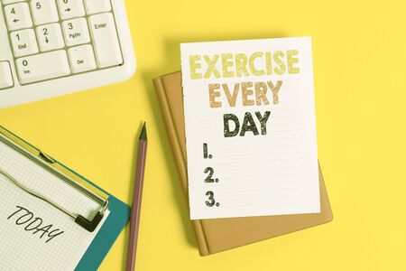 Writing note showing Exercise Every Day. Business concept for move body energetically in order to get fit and healthy Pile of empty papers with copy space on the tableの写真素材