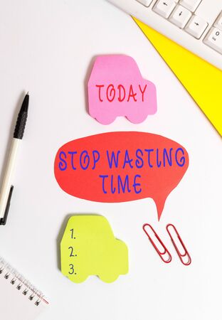 Conceptual hand writing showing Stop Wasting Time. Concept meaning advising demonstrating or group start planning and use it Red bubble copy space paper on the table with clockの写真素材