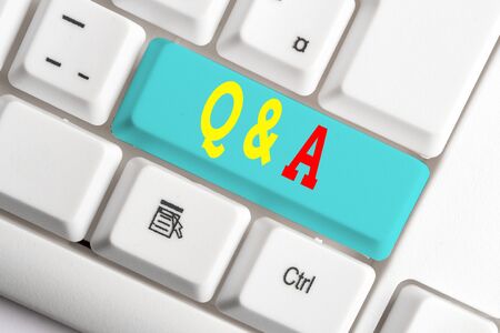 Text sign showing Q And A. Business photo showcasing a period of time or an occasion when someone answers questions White pc keyboard with empty note paper above white background key copy spaceの写真素材