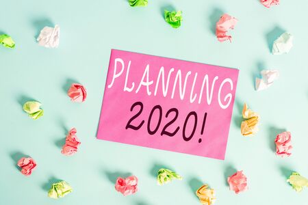 Writing note showing Planning 2020. Business concept for process of making plans for something next year Colored crumpled rectangle shaped reminder paper light blue backgroundの写真素材