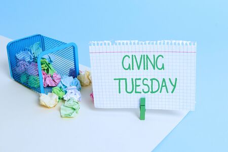Text sign showing Giving Tuesday. Business photo text international day of charitable giving Hashtag activism Trash bin crumpled paper clothespin empty reminder office supplies tippedの写真素材