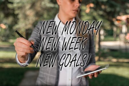 Text sign showing New Monday New Week New Goals. Business photo text goodbye weekend starting fresh goals targets Outdoor background with business woman holding lap top and penの写真素材