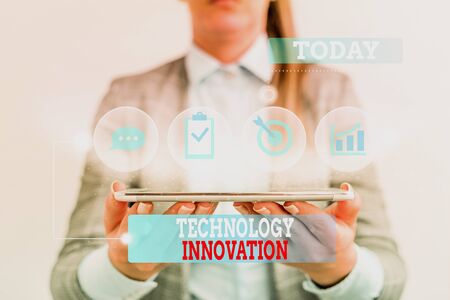 Handwriting text writing Technology Innovation. Conceptual photo significant technological changes of products Female human wear formal work suit presenting presentation use smart deviceの写真素材