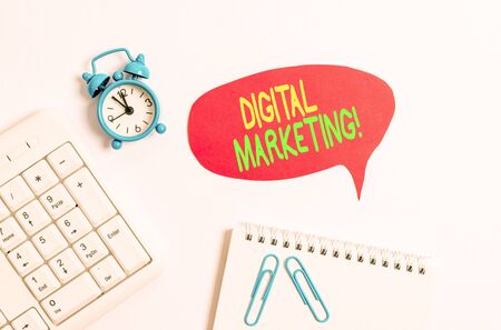 Word writing text Digital Marketing. Business photo showcasing market products or services using technologies on Internet Blank paper with copy space on the table with clock and pc keyboardの写真素材