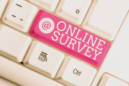 Writing note showing Online Survey. Business concept for Reappraisal Feedback Poll Satisfaction Rate Testimony White pc keyboard with note paper above the white backgroundの写真素材