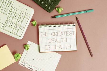 Handwriting text writing The Greatest Wealth Is Health. Conceptual photo Many sacrifice their money just to be healthy Writing equipments and computer stuffs placed above classic wooden tableの写真素材