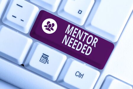 Word writing text Mentor Needed. Business photo showcasing wanted help for more experienced or more knowledgeable demonstrating White pc keyboard with empty note paper above white background key copy spaceの写真素材