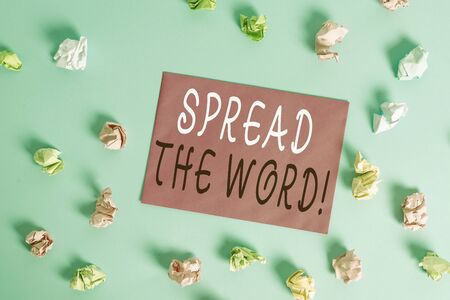 Writing note showing Spread The Word. Business concept for share the information or news using social media Colored crumpled rectangle shaped reminder paper light blue backgroundの写真素材