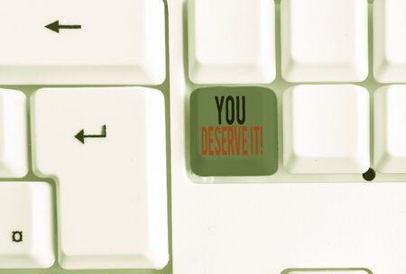 Text sign showing You Deserve It. Business photo text should have it because of their qualities or actions White pc keyboard with empty note paper above white background key copy spaceの写真素材