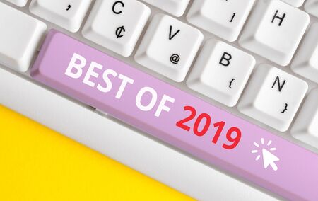 Writing note showing Best Of 2019. Business concept for great and marvelous things and events happened on 2019 White pc keyboard with note paper above the white backgroundの写真素材