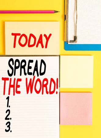 Conceptual hand writing showing Spread The Word. Concept meaning share the information or news using social media Empty papers with copy space on yellow background tableの写真素材