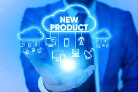 Handwriting text New Product. Conceptual photo goods and services that differ in their characteristics Male human wear formal work suit presenting presentation using smart deviceの写真素材