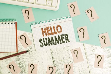 Text sign showing Hello Summer. Business photo showcasing Welcoming the warmest season of the year comes after spring Writing tools, computer stuff and math book sheet on top of wooden tableの写真素材