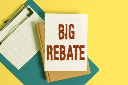 Word writing text Big Rebate. Business photo showcasing Huge rewards that can get when you engaged to a special promo Pile of empty papers with copy space on the tableの写真素材