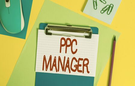 Word writing text Ppc Manager. Business photo showcasing which advertisers pay fee each time one of their ads is clicked Clipboard striped sheets marker clips notepad mouse colored backgroundの写真素材