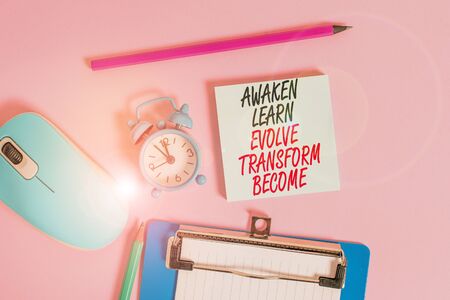 Conceptual hand writing showing Awaken Learn Evolve Transform Become. Concept meaning Inspiration Motivation Improve Alarm clock notepad clipboard paper markers color backgroundの写真素材