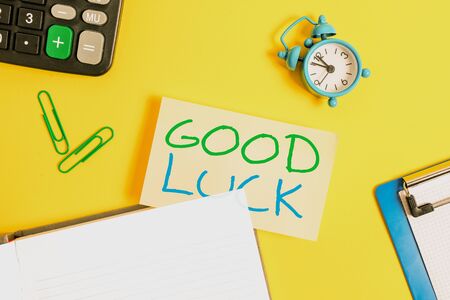 Text sign showing Good Luck. Business photo showcasing A positive fortune or a happy outcome that a demonstrating can have Empty orange paper with copy space on the yellow tableの写真素材