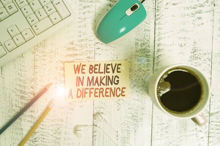 Conceptual hand writing showing We Believe In Making A Difference. Concept meaning selfconfidence that can be unique Technological devices colored reminder paper office suppliesの写真素材