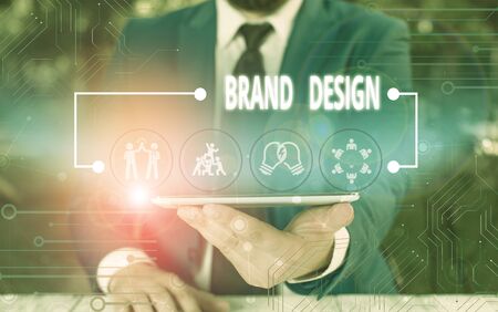 Writing note showing Brand Design. Business concept for visual elements that make up the corporate or brand identity Male wear formal work suit presenting presentation smart deviceの写真素材