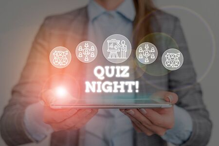 Conceptual hand writing showing Quiz Night. Concept meaning evening test knowledge competition between individuals Woman wear work suit presenting presentation smart deviceの写真素材