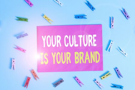 Conceptual hand writing showing Your Culture Is Your Brand. Concept meaning Knowledge Experiences are a presentation card Colored clothespin rectangle shaped paper blue backgroundの写真素材