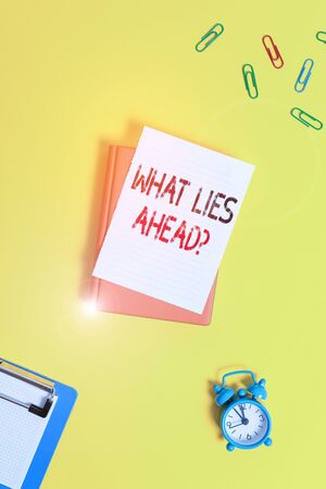 Writing note showing What Lies Ahead Question. Business concept for Asking for information about something on the way Paper clips with blank papers for text messagesの写真素材