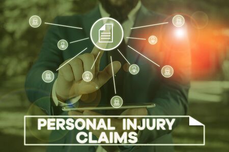 Handwriting text writing Personal Injury Claims. Conceptual photo being hurt or injured inside work environment Male human wear formal work suit presenting presentation using smart deviceの写真素材