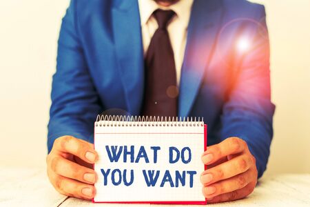 Word writing text What Do You Want. Business photo showcasing used for offering something to someone or asking their need Man holds empty paper with copy space in front of him Spaceの写真素材