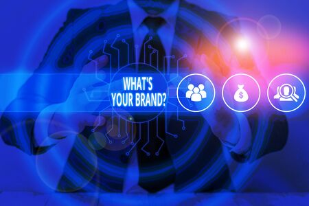 Text sign showing What S Your Brand Question. Business photo text asking about product logo does or what you communicate Male human wear formal work suit presenting presentation using smart deviceの写真素材